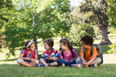 school-children-sitting-grass-sunny-day-49900187